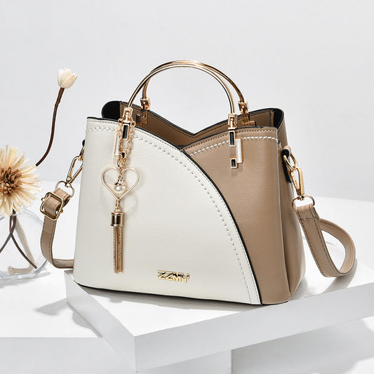 LuxeAura: The Color Block Handbag with Love Tassel Decor, a stylish  bag designed to add flair to any ensemble.