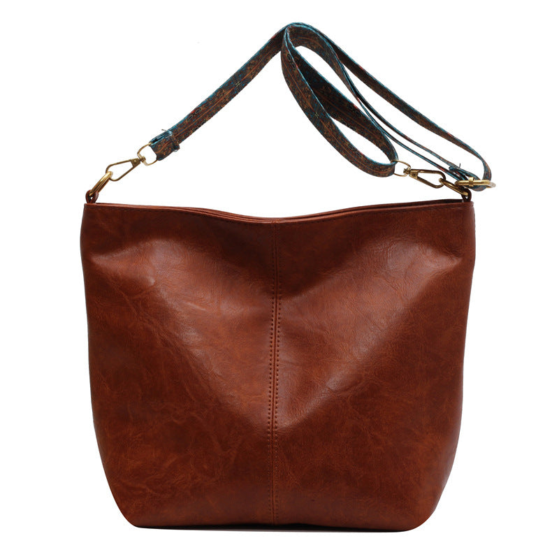 LuxeAura: The Retro Bucket Bag with Wide Shoulder Strap, a stylish accessory for daily outings.