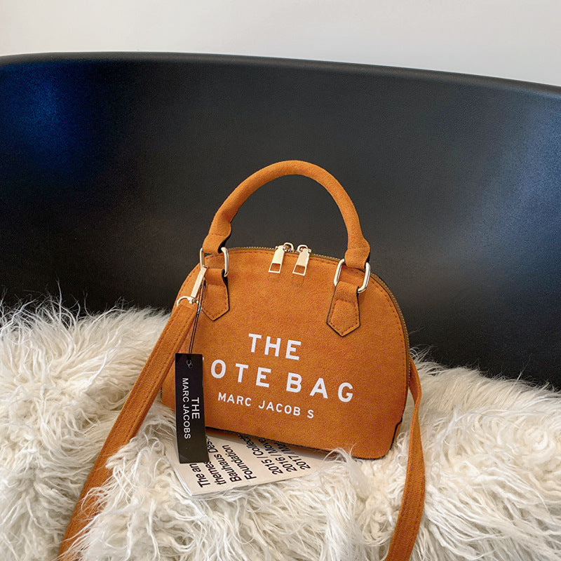 LuxeAura: The Shell Bag, a new addition to women's fashion crafted from sleek PU material, blending simplicity with style for a contemporary look.